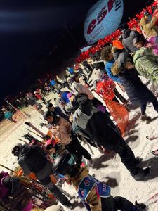 a group of people standing in the snow with skis at Appartement T3 cosy sur les pistes avec parking in Le Grand-Bornand