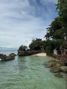a view of a beach with rocks in the water at Sea La Vie Guesthouse in Pooc +15 photos