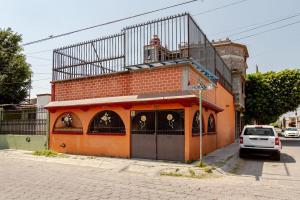 an orange building with a balcony on top of it at Equipped house in Santa Monica 2nd Section, Qro in Adjuntas