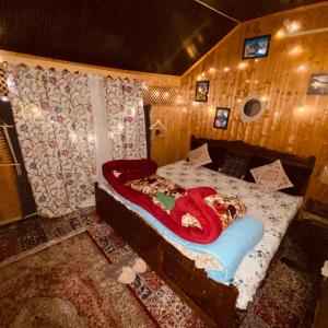 a bedroom with a bed with a red snake on it at Houseboat Blackpearl in Srinagar