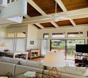 a living room with a couch and a ceiling fan at Princeville North Shore Retreat - 1200 SF, Lanai, Loft & Kitchen in Princeville