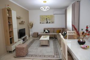 a living room with a couch and a table at Lana's House in Berat