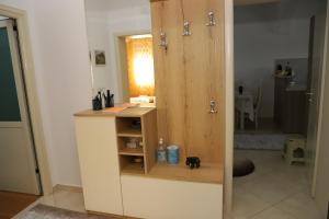 a bathroom with a wooden cabinet with a dog in it at Lana's House in Berat +47 photos