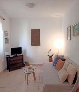 a living room with a couch and a table at Apartment Roko in Podstražje