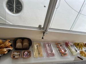 a refrigerator filled with lots of different types of food at Nascimento Suites in Búzios