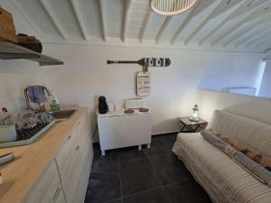 a kitchen with a couch and a sink in a room at Quinta da Atafona in Ribeirinha +36 photos