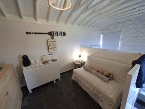 a living room with a couch and a table at Quinta da Atafona in Ribeirinha