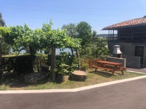 a picnic bench and trees in front of a building at Casa Pepe La Granda in Trasona