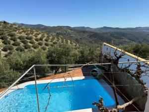 a swimming pool with a view of the hills at Cortijo El Nevazo II in Fuentes de Cesna