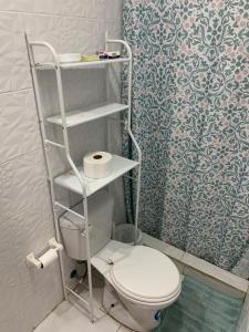a small bathroom with a toilet and a shower at Hospedaje Antonela in Manta