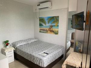 a bedroom with a bed and a television in it at Hospedaje Antonela in Manta