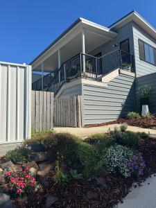 a house with a balcony and some flowers at Guest favourite Ocean Views Breakfast Included in Charlestown