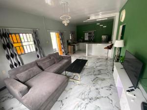 a living room with a couch and a table at Augi's Rental in Onverwacht