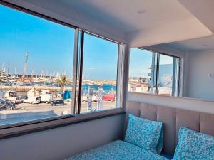 a room with a couch and a window with a view of a harbor at Guest House Vasco da Gama in Lagos