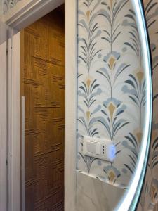 a mirror in a room with a wall at Almía apartment in Cinisi +19 photos