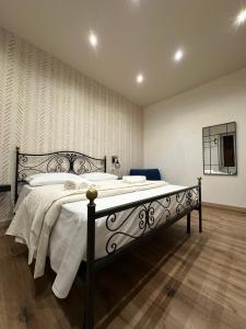 a bedroom with a large bed with white sheets at Almía apartment in Cinisi