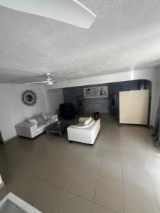 a large living room with two couches and a table at Mawoon House in Friar's Bay