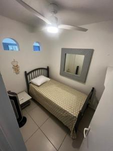 a bedroom with a bed and a mirror on the wall at Mawoon House in Friar's Bay