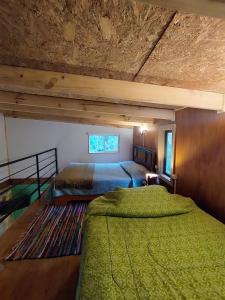 a bedroom with two beds in a room at Refugió Chaicura in Notuél