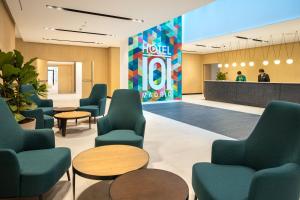 a waiting room at a hotel with chairs and tables at Hotel101 - Madrid in Madrid +16 photos