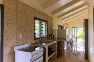 a kitchen with a sink and a stove at Hidden Haven - Group Retreat-Sleeps 7 aircon & free Wifi in Rarotonga