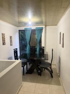 a dining room with a table and chairs and a window at La Estancia Tolimense in Ibagué