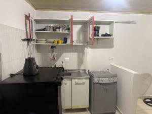 a small kitchen with a counter and a stove at La Estancia Tolimense in Ibagué