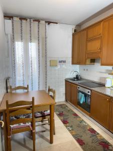 a kitchen with a wooden table and a table and chairs at Altobello Venice Apartment in Mestre