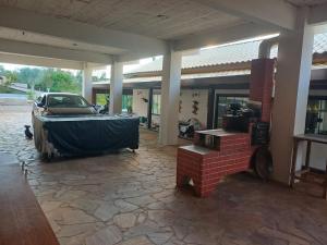 a house with a car parked in a courtyard at Casa ampla e completa para você e sua família in Soledade de Minas