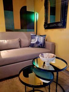 a living room with a couch and a glass table at SuiteArtate in Patra