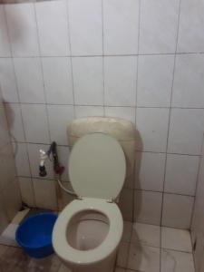 a bathroom with a toilet in a tiled room at dankotuwa in Seeduwa +4 photos