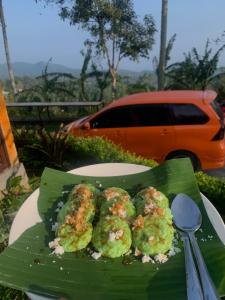 a plate of food on top of a banana leaf at Giri Garden Sunset Glamping in Gitgit
