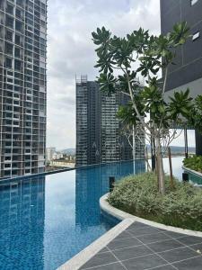 a swimming pool in a city with tall buildings at QH Guesthouse in Shah Alam