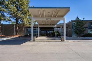 a building with a shelter in front of it at Suburban Studios Canon City in Canon City