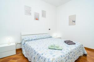 a white bedroom with a bed and two towels on it at Relax Between Cinque Terre and Portofino in Moneglia