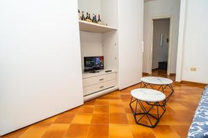 a living room with two tables and a tv at Relax Between Cinque Terre and Portofino in Moneglia