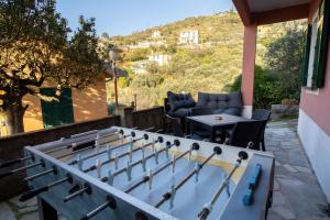 a ping pong set up on a patio with a table at Relax Between Cinque Terre and Portofino in Moneglia