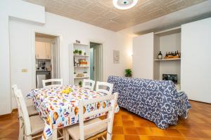 a dining room with a table and chairs and a couch at Relax Between Cinque Terre and Portofino in Moneglia