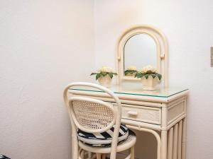 a dressing table with a mirror and a chair at Holiday home in Marstal in Brovst