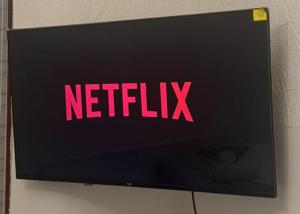 a netflix sign on the side of a television at Self-contained Studio near Tottenham Hotspurs stadium in London