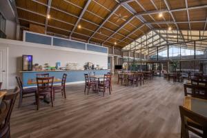 a restaurant with tables and chairs in a room at Suburban Studios Canon City in Canon City