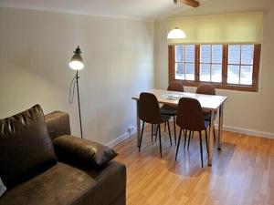 a living room with a couch and a table and chairs at Bernsteinsee Home and Ferien Forest Chalet in Sassenburg