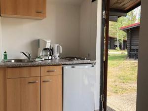 a kitchen with a sink and a counter top at Bernsteinsee Home and Ferien Small Forest Chalet in Sassenburg