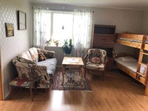 a living room with a couch and a bunk bed at Charming Red Farmhouse Near Forsheda in Krokom