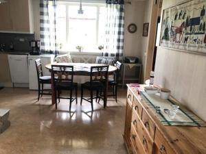 a kitchen and dining room with a table and chairs at Charming Red Farmhouse Near Forsheda in Krokom