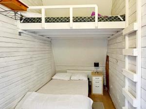 two beds in a small room with white walls at 9 person holiday home in Mörlunda-By Traum in Mörlunda