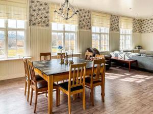 a dining room with a wooden table and chairs at 9 person holiday home in Mörlunda-By Traum in Mörlunda
