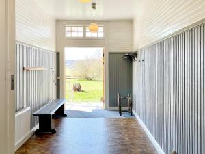 a hallway with a bench and a sliding door at 9 person holiday home in Mörlunda-By Traum in Mörlunda
