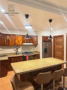 a kitchen with a granite counter top and wooden cabinets at Acogedorapartamento entre montañas in Pedro Brand