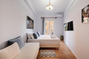 a bedroom with a bed and a couch at Venetian Balcony , Old Town Corfu in Corfu